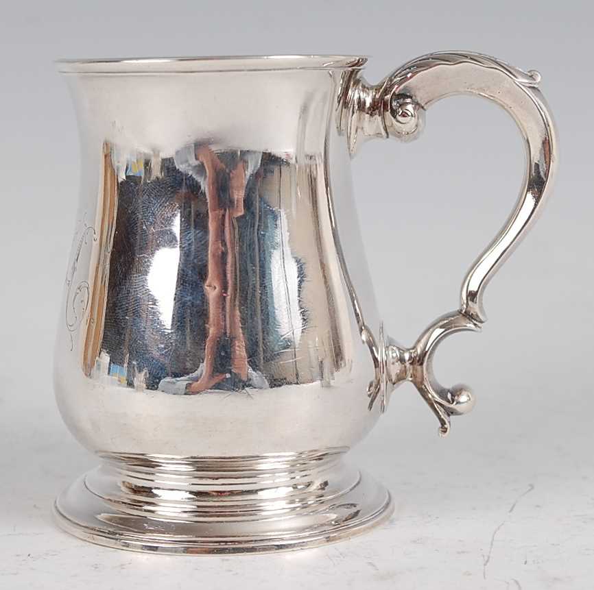 Lot 1096 - A George II silver bell shaped tankard, having...