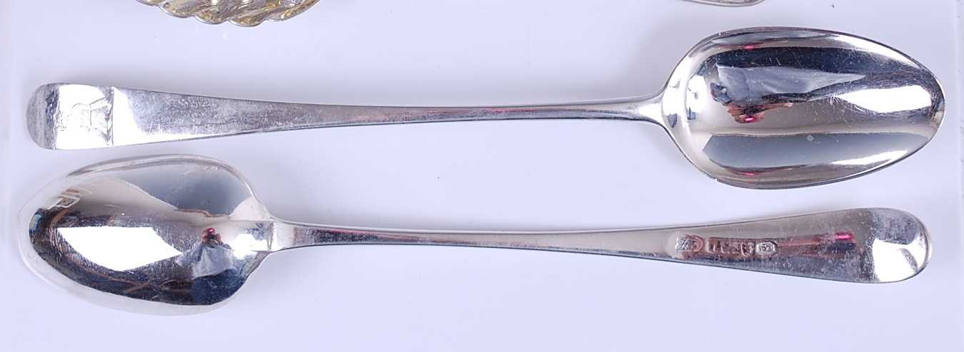 Lot 1109 - A pair of George III silver basting spoons,...