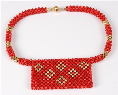 Lot 1199 - A beaded coral and yellow metal choker, the...