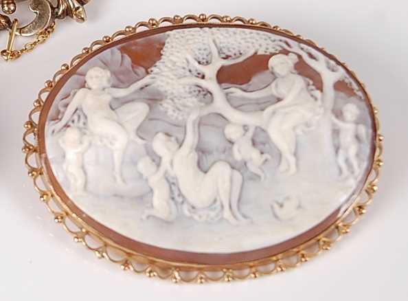 Lot 1205 - A carved shell cameo brooch depicting children...