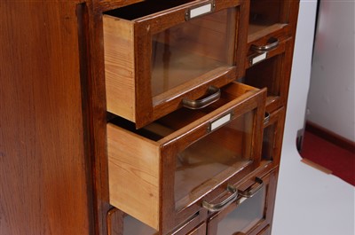 Lot 428 - An Art Deco oak narrow haberdashery cabinet,...
