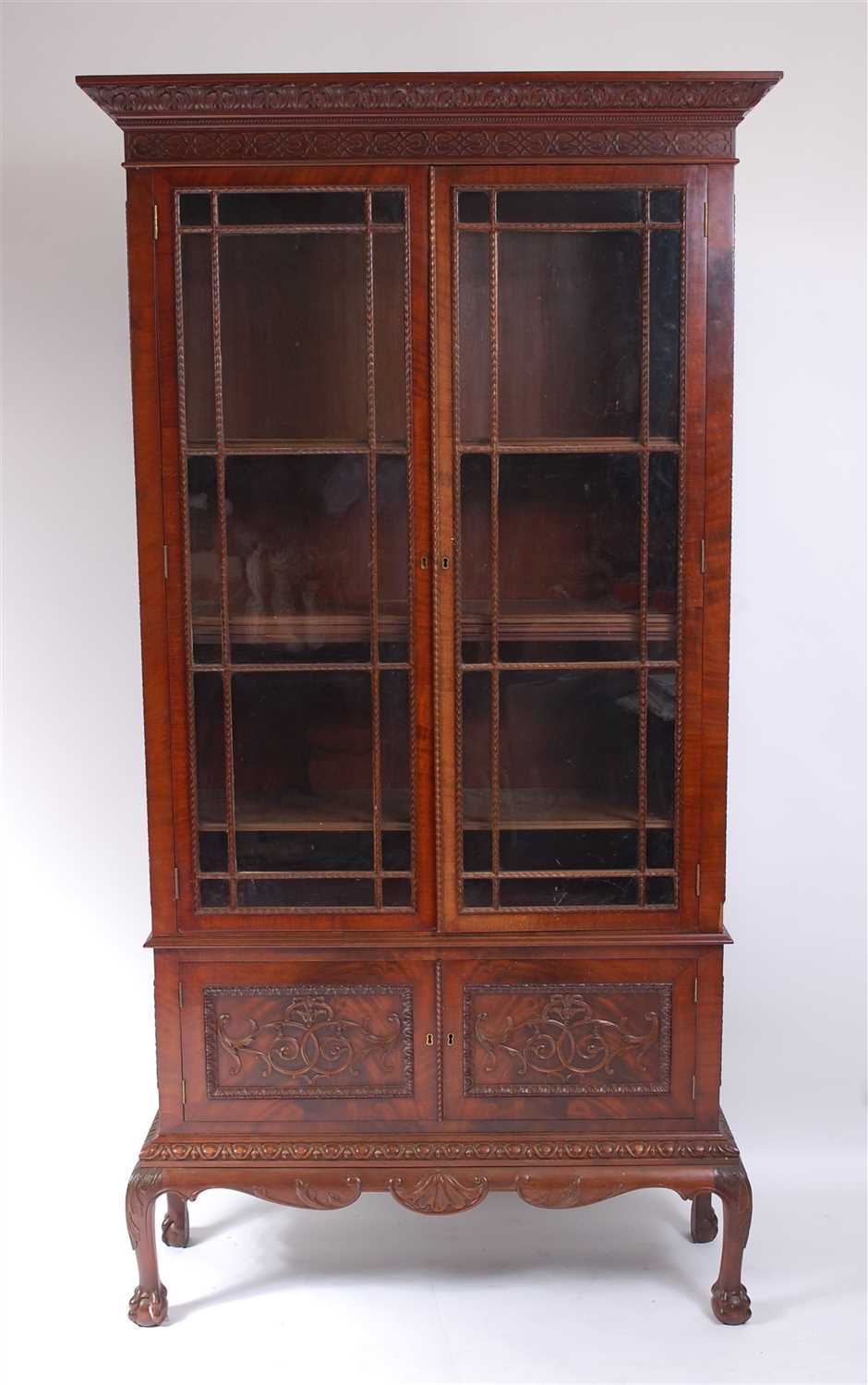 Lot 1481 - A circa 1900 mahogany bookcase on stand, the...