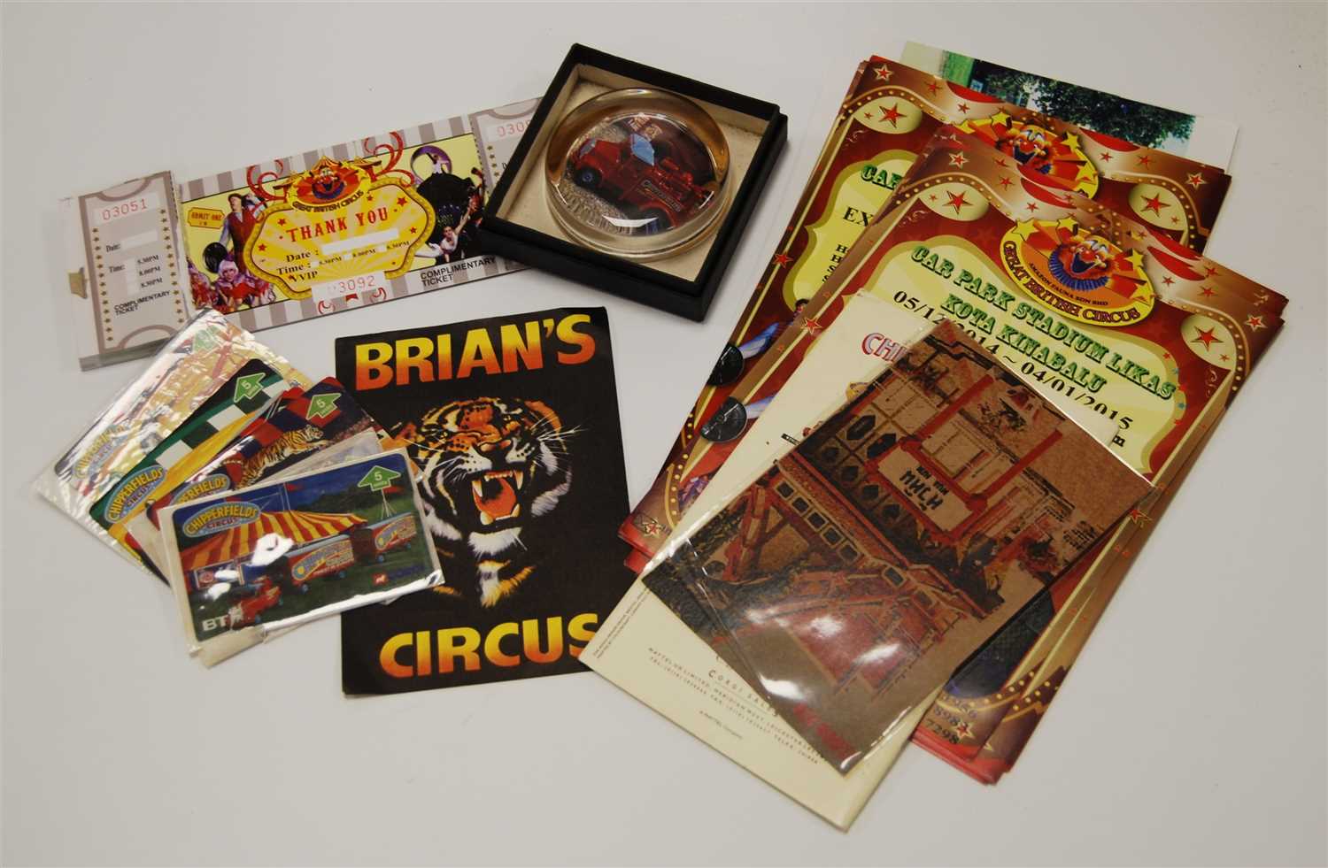 Lot 371 - A collection of circus related items, to include leaflets, ephemera, photographs, BT phone cards, a ticket book and a paperweight