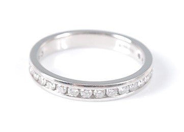Lot 2634 - A platinum diamond half hoop eternity ring,...