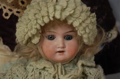 Lot 2060 - An unmarked bisque head and shouldered doll,...
