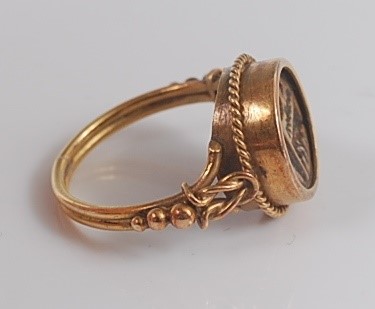 Lot 2641 - A yellow metal circular signet ring, the ring...