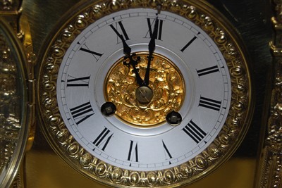 Lot 5 - A brass mantel clock having applied cast...