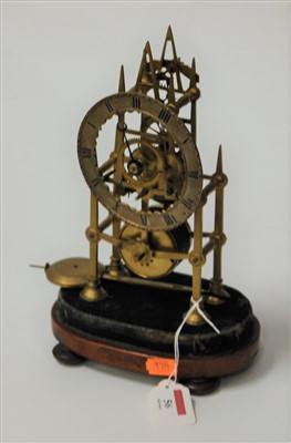 Lot 56 - A late Victorian brass skeleton clock, having...
