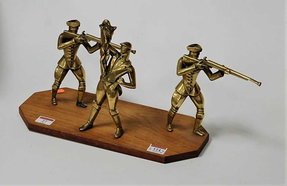 Lot 124 - A brass sculpture modelled as three huntsmen...