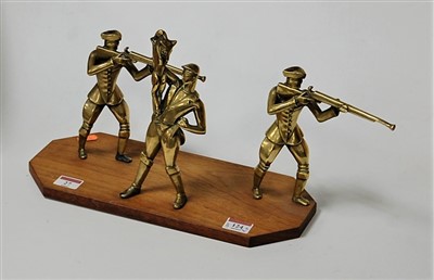 Lot 124 - A brass sculpture modelled as three huntsmen...