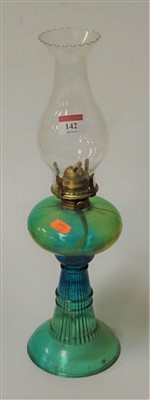 Lot 142 - A moulded green glass pedestal oil lamp
