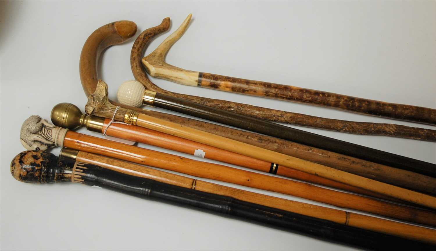 Lot 145 - A collection of reproduction walking canes to...