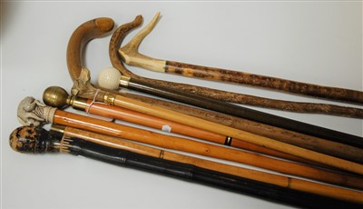 Lot 145 - A collection of reproduction walking canes to...
