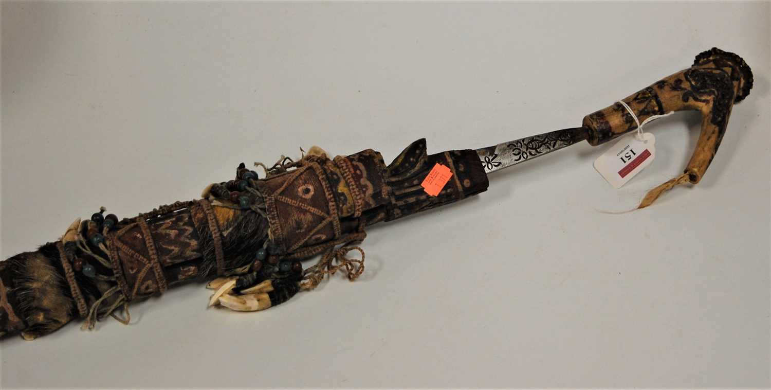 Lot 151 - A Borneo head hunter's sword with a carved...