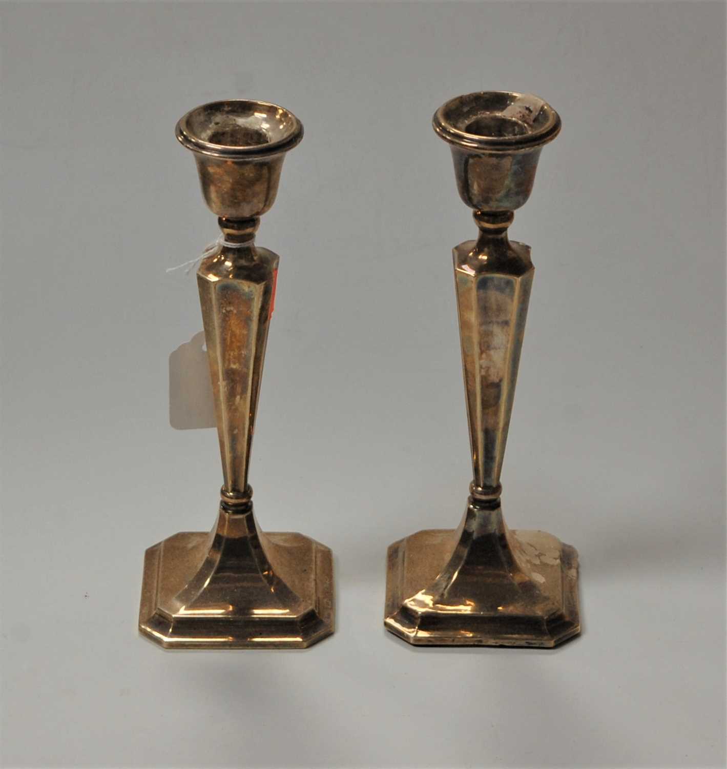 Lot 273 - A pair of 20th century silver candlesticks,...