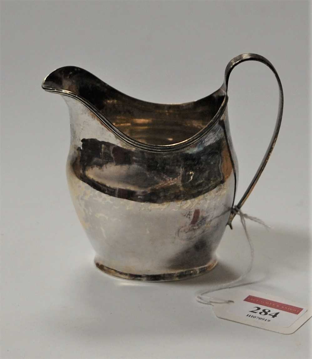 Lot 284 - A George III silver helmet shaped cream jug,...