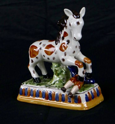 Lot 332 - A circus horse and trainer pottery figure...