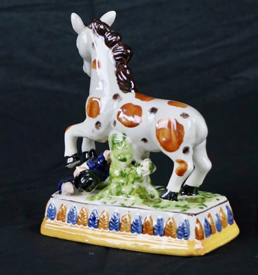 Lot 332 - A circus horse and trainer pottery figure...