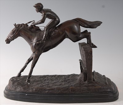 Lot 450 - A large bronze figure of a racehorse and jockey jumping a hurdle