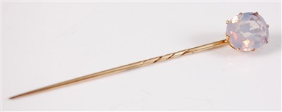 Lot 2626 - A yellow metal sapphire stick pin, the oval...