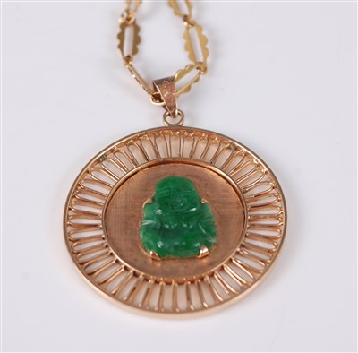 Lot 2670 - A yellow metal circular jadeite pendant, the...