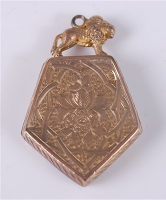 Lot 2671 - A yellow metal shield shaped locket, engraved...