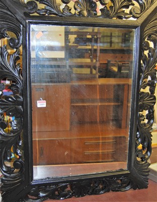 Lot 1122 - A carved and later painted wood bevelled...