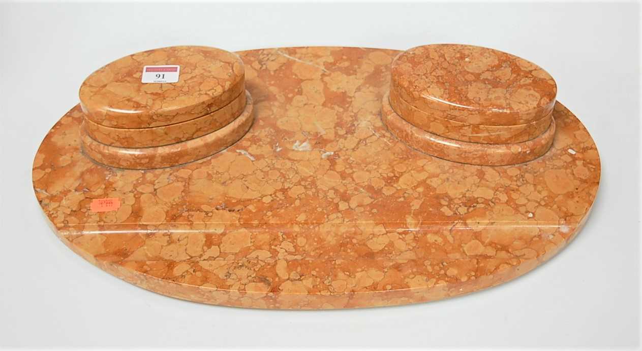 Lot 91 - An Art Deco rouge marble desk stand of oval...