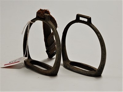 Lot 229 - A pair of steel stirrups, one with leather strap