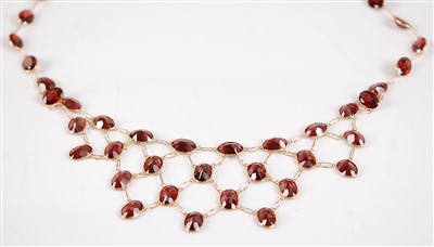 Lot 2682 - A contemporary 18ct gold and garnet necklace,...