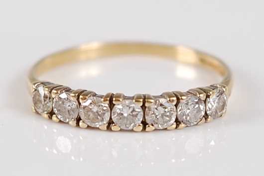 Lot 2688 - An 18ct gold diamond half hoop ring, arranged...