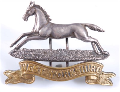 Lot 24 - A West Yorkshire Regiment Officer's white metal and gilt cap badge