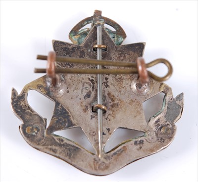 Lot 25 - An East Surrey Regiment Officer's white metal and gilt cap badge