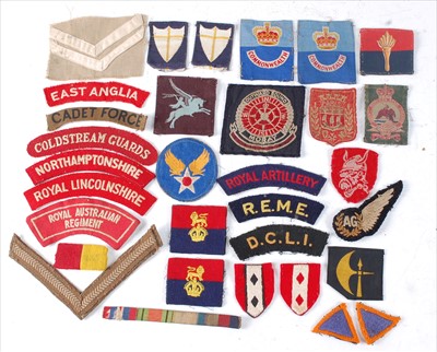 Lot 238 - A collection of cloth formation signs, shoulder titles, lapel badges and buttons to include