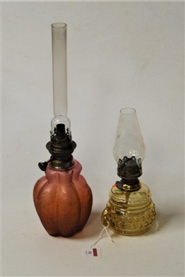 Lot 16 - A late Victorian oil lamp, the pink tinted...