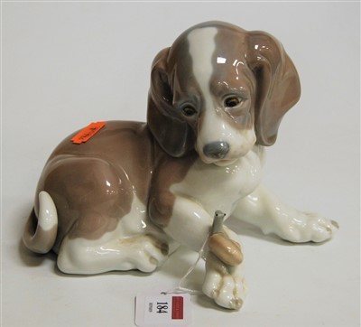 Lot 184 - A Lladro porcelain figure of a recumbent puppy...