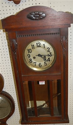 Lot 1118 - An early 20th century oak droptrunk wall clock