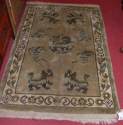 Lot 1143 - A Chinese green ground rug, the central ground...