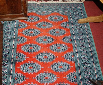 Lot 1146 - A Persian woollen red ground Bokhara rug,...