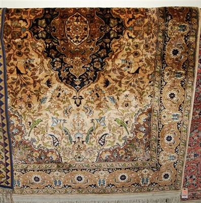 Lot 1149 - A Persian woollen cream ground carpet, the...