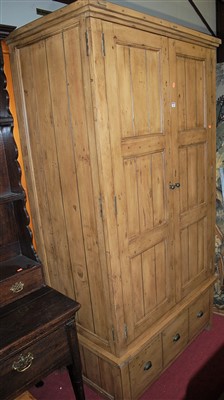 Lot 1166 - A reclaimed pine double door wardrobe, having...