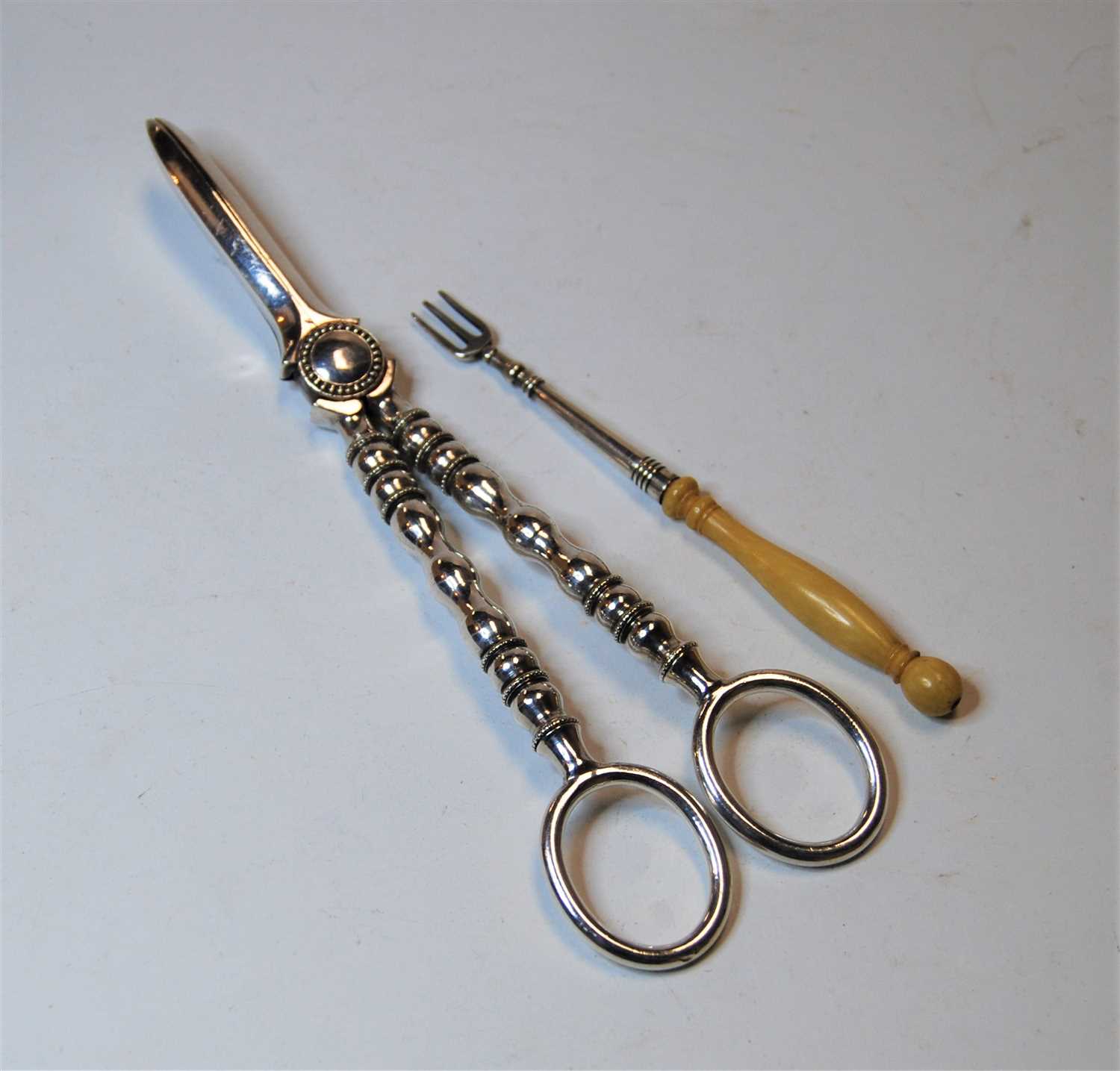 Lot 305 - A pair of silver plated grape scissors;...