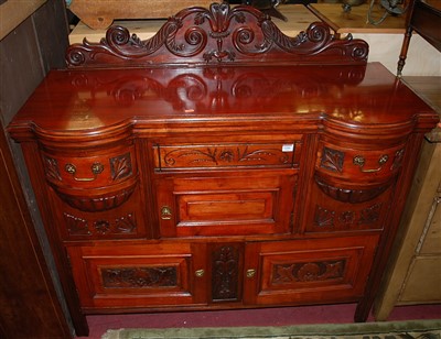 Lot 1216 - An Edwardian stained and relief carved walnut...