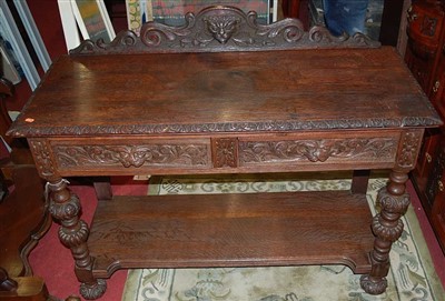 Lot 1223 - A circa 1900 heavily carved oak ledgeback two...