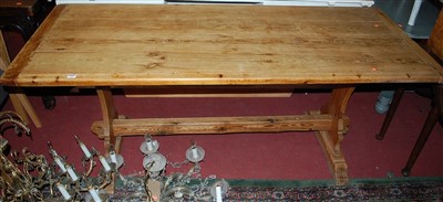 Lot 1301 - An early 20th century pine plank top trestle...