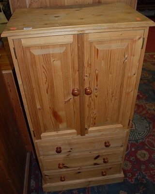 Lot 1314 - A modern pine narrow double door side cupboard,...