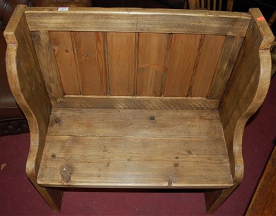 Lot 1333 - A small stained pine panelled pew, width 80cm