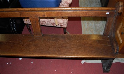 Lot 1338 - A late Victorian oak long church pew having a...