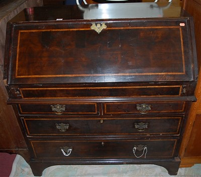 Lot 1361 - An antique stained walnut slopefront writing...