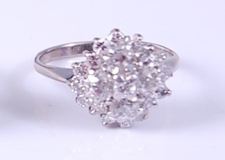 Lot 2123 - A white metal diamond circular cluster ring,...